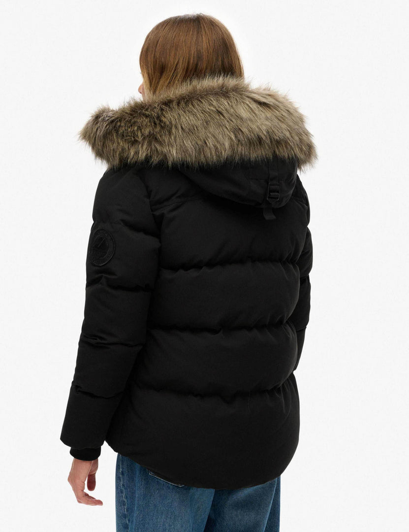 Side view of the women's black hooded funnel neck puffer jacket

