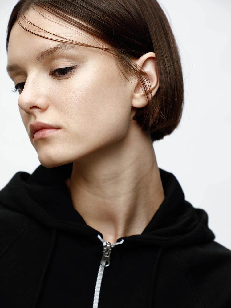 Close-up front view of black hooded jacket

