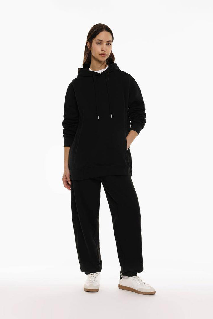 Full body front view of woman wearing black oversized plush sweatshirt

