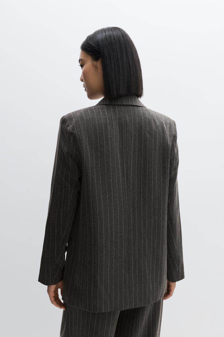 Back view of a black women's pinstripe blazer
