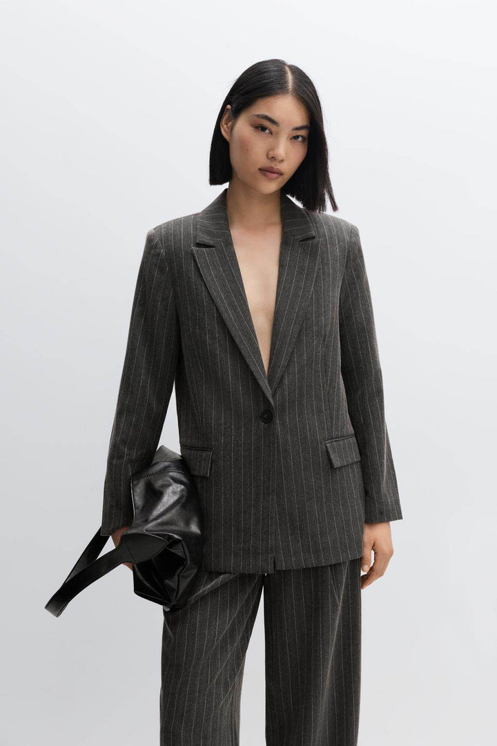Front full body view of a black women's pinstripe blazer

