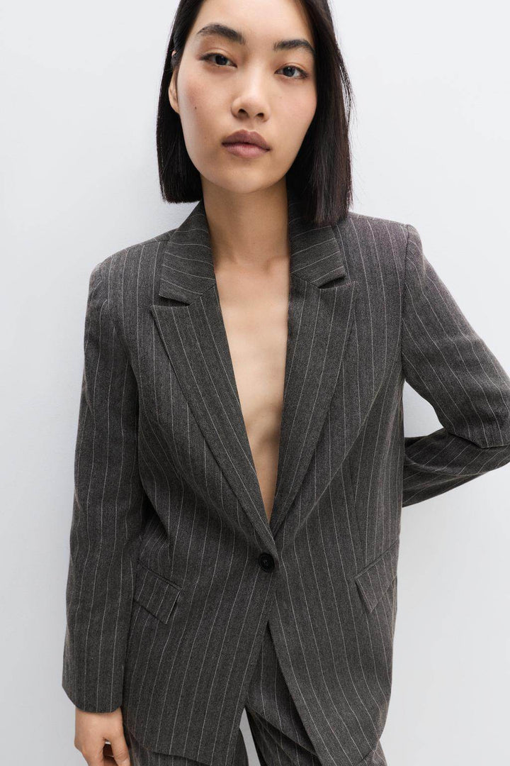 Front view of a black women's pinstripe blazer
