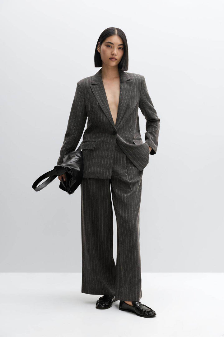 Front full body view of a black women's pinstriped blazer
