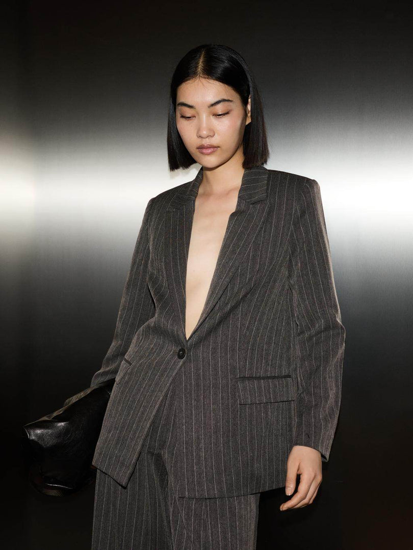 Front view of a black women's pinstriped blazer
