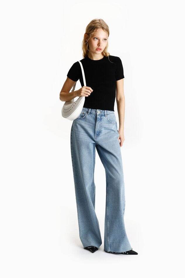 Full body front view of woman wearing black ribbed knit t-shirt

