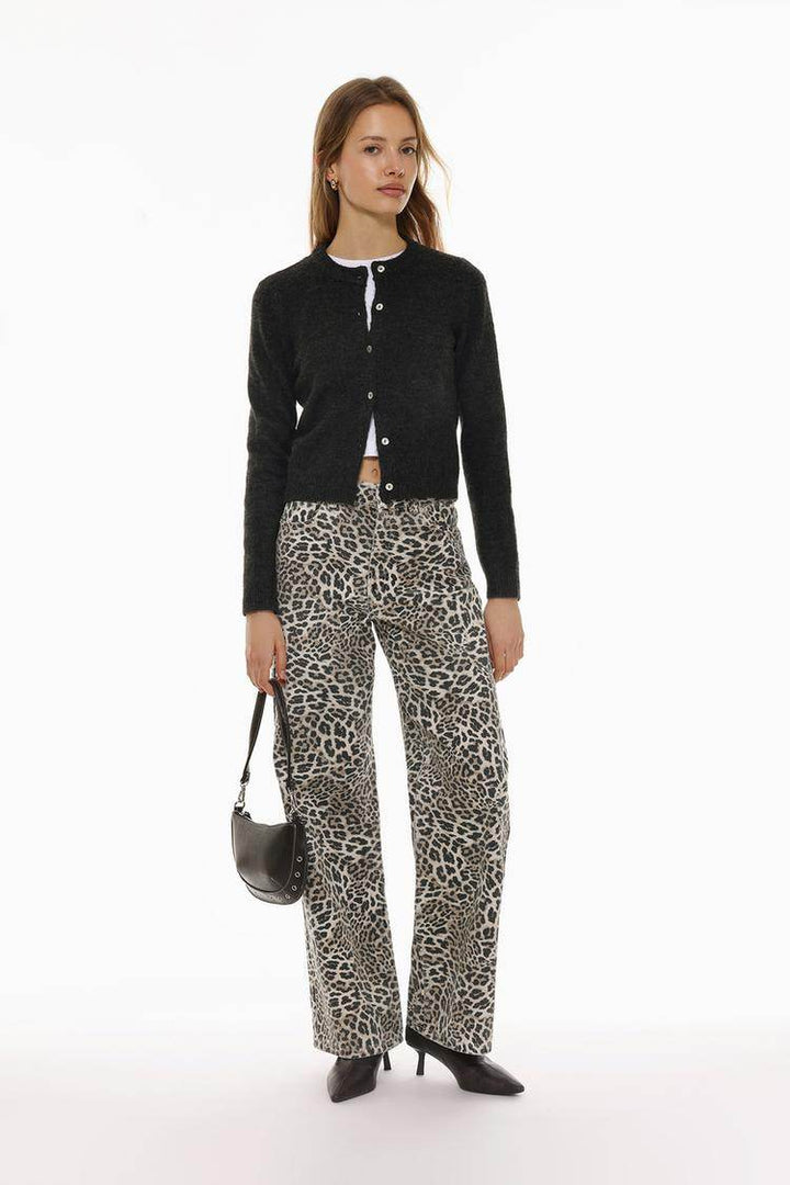 Full body front view of woman wearing black knit cardigan

