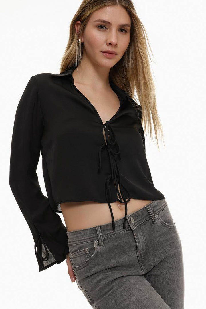 Side view of the women's black satin shirt with ties

