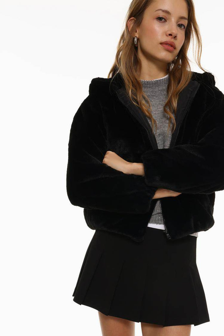 Close-up front view of black short soft coat

