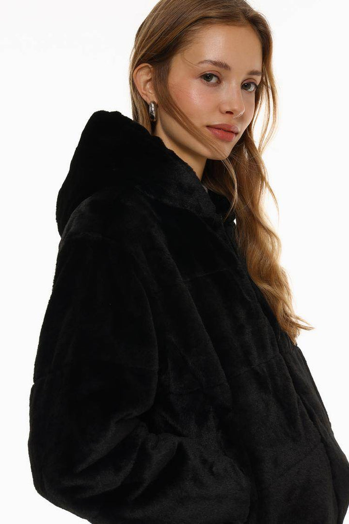 Side view of the women's black short soft coat

