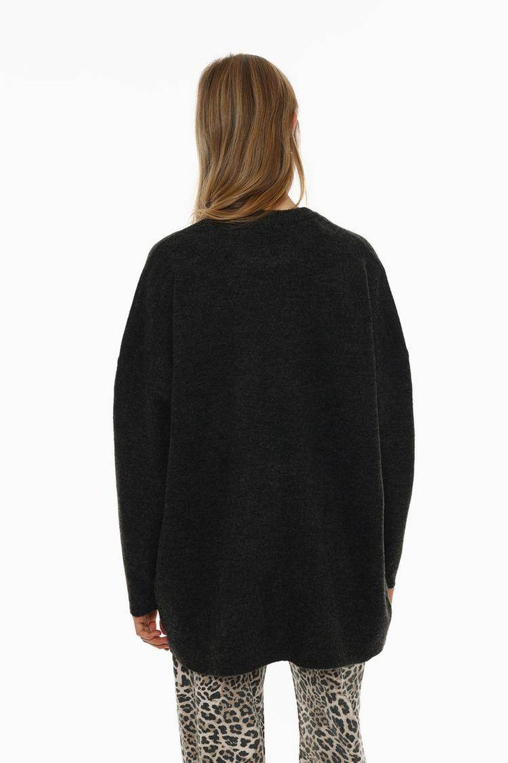 Back view of the women's black soft knit oversize jumper

