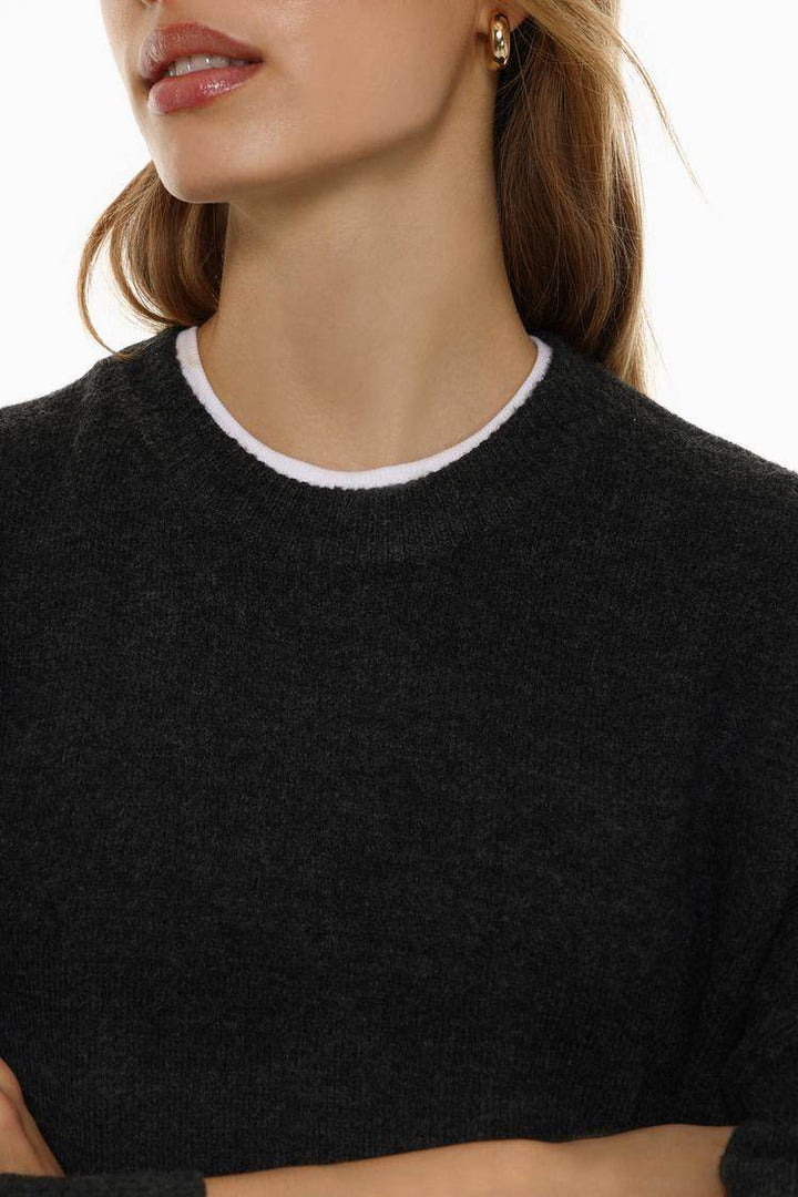 Close-up front view of black soft knit jumper

