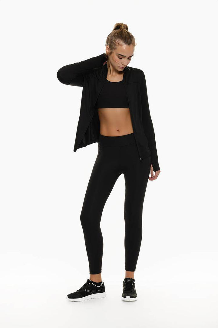 Full body front view of woman wearing black sports jacket

