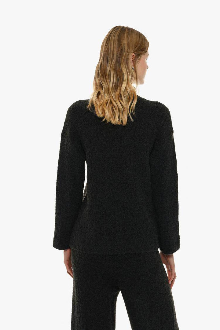 Back view of the women's black textured knit sweater

