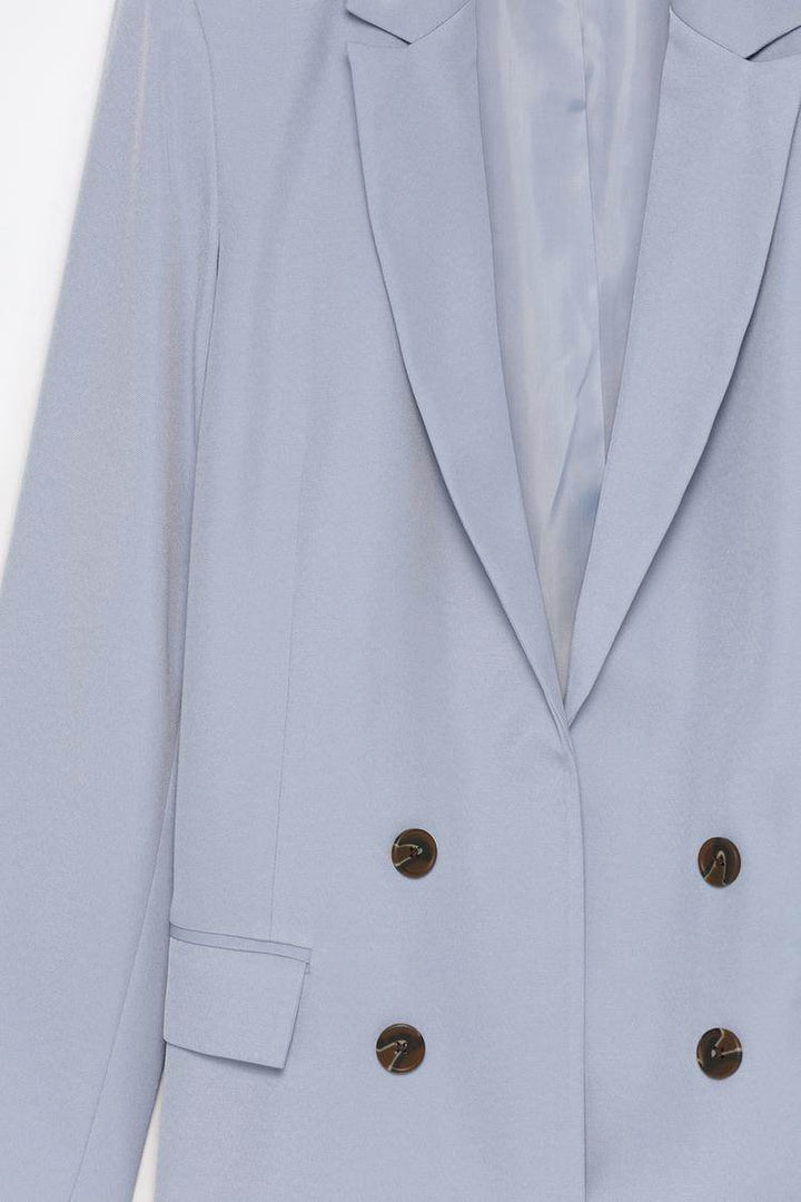 Close-up product image of blue blazer fabric

