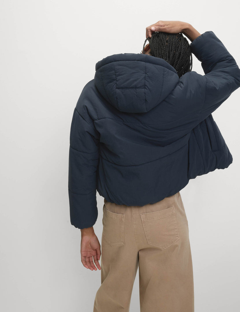 Back view of the women's blue hooded puffer jacket

