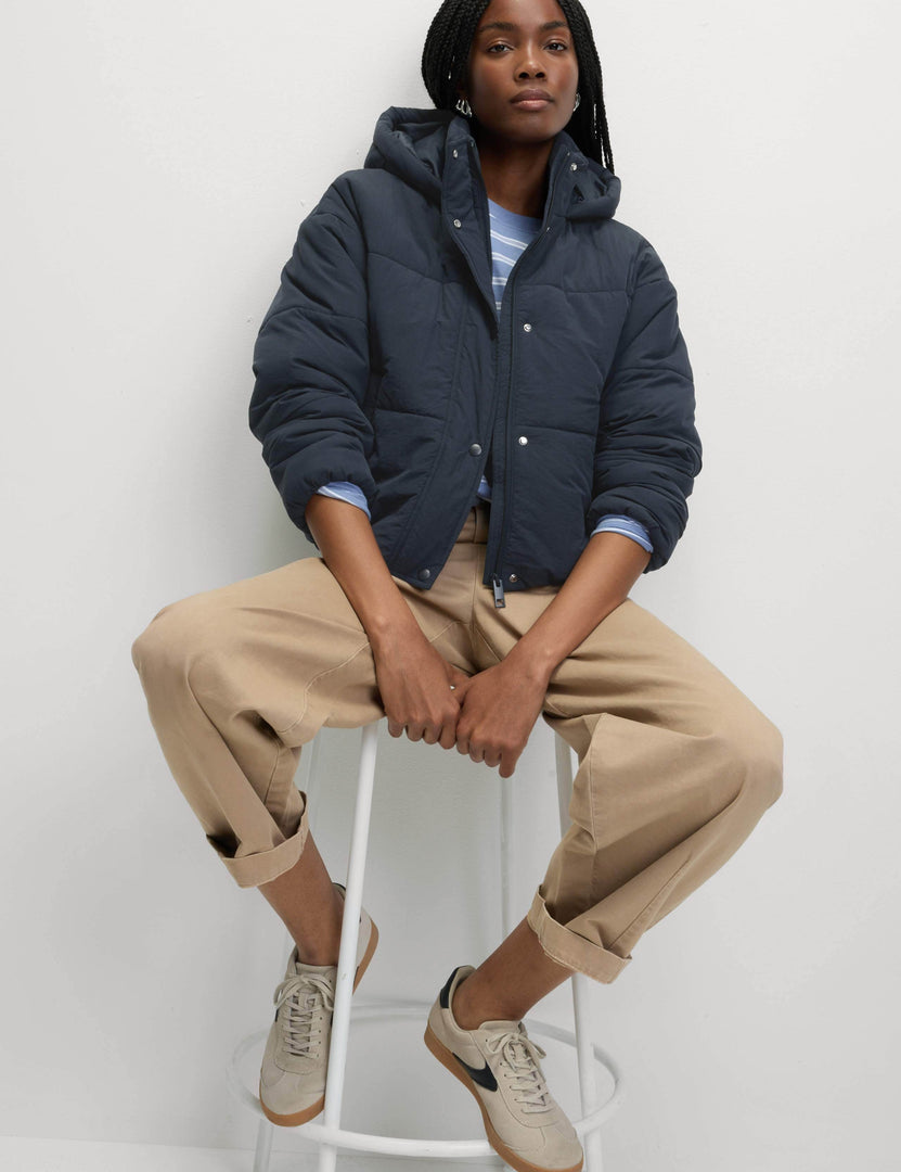 Front view of a women's blue hooded puffer jacket

