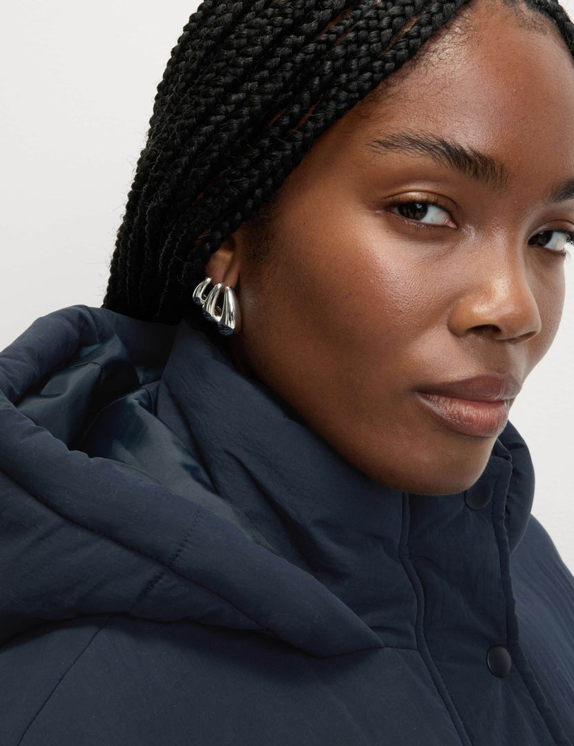 Side view of the women's blue hooded puffer jacket

