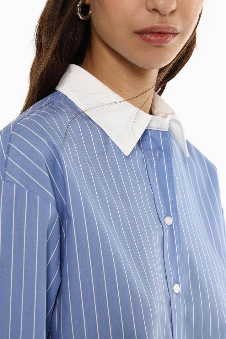 Model showcasing front of blue oversized shirt

