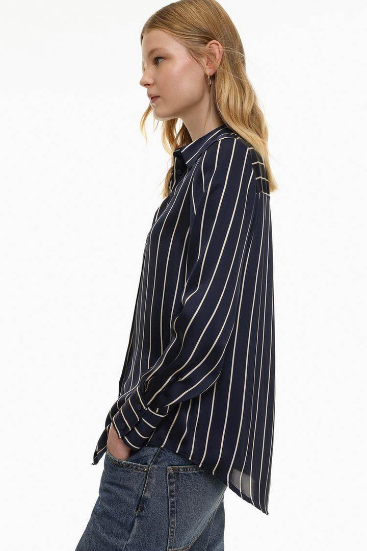 Zoomed in side view of blue satin shirt

