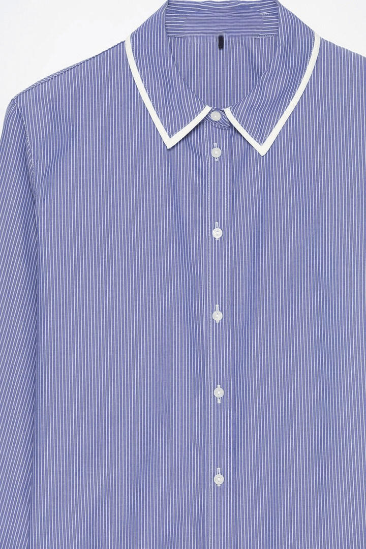 Close-up product image of blue striped shirt fabric

