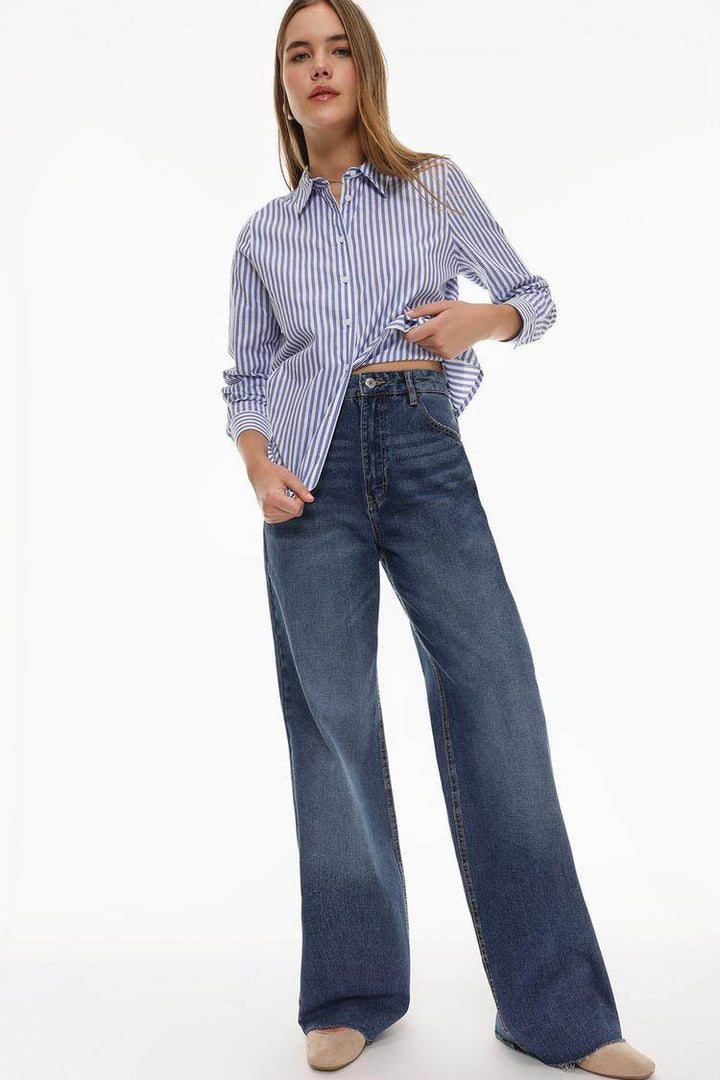 Model showcasing the front of the blue wide-leg jeans

