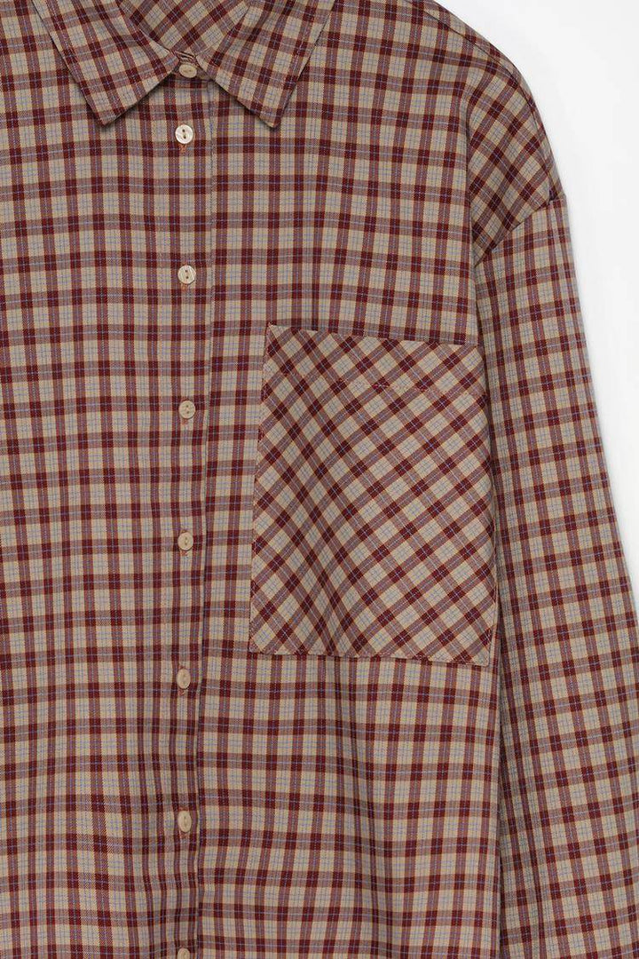 Close-up product image of brown checked shirt fabric


