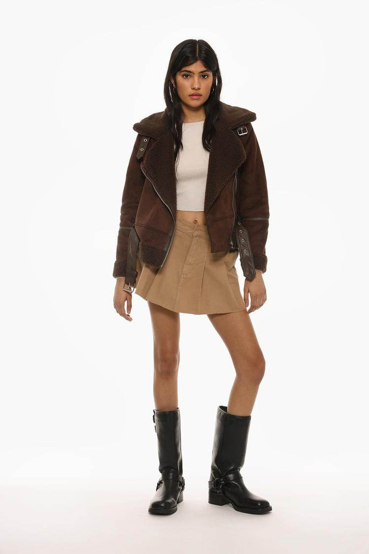 Full body front view of woman wearing brown double-faced crossover jacket

