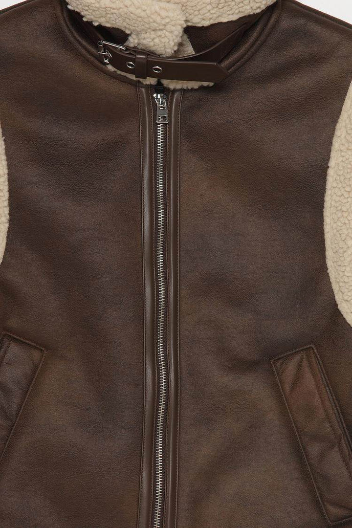 Close-up product image of brown gilet zipper and fabric

