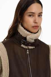 Close-up front view of brown double-faced gilet with zip

