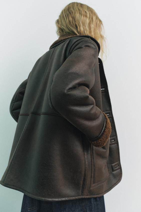 Model showcasing brown faux leather reversible coat

