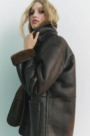 Side view of the women's brown faux leather reversible coat

