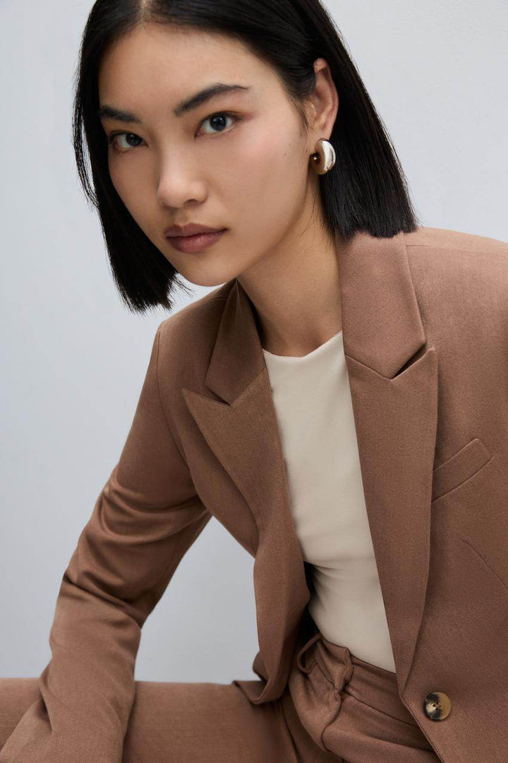 Zoomed front view of a brown women's fitted blazer
