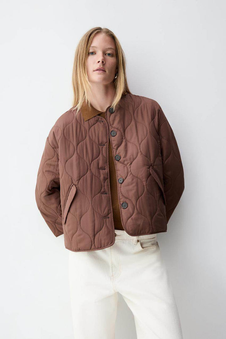 Zoomed out front view of the women's brown quilted jacket

