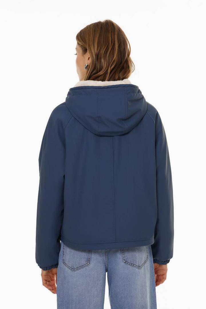 Back view of the women's dark blue rubberised parka

