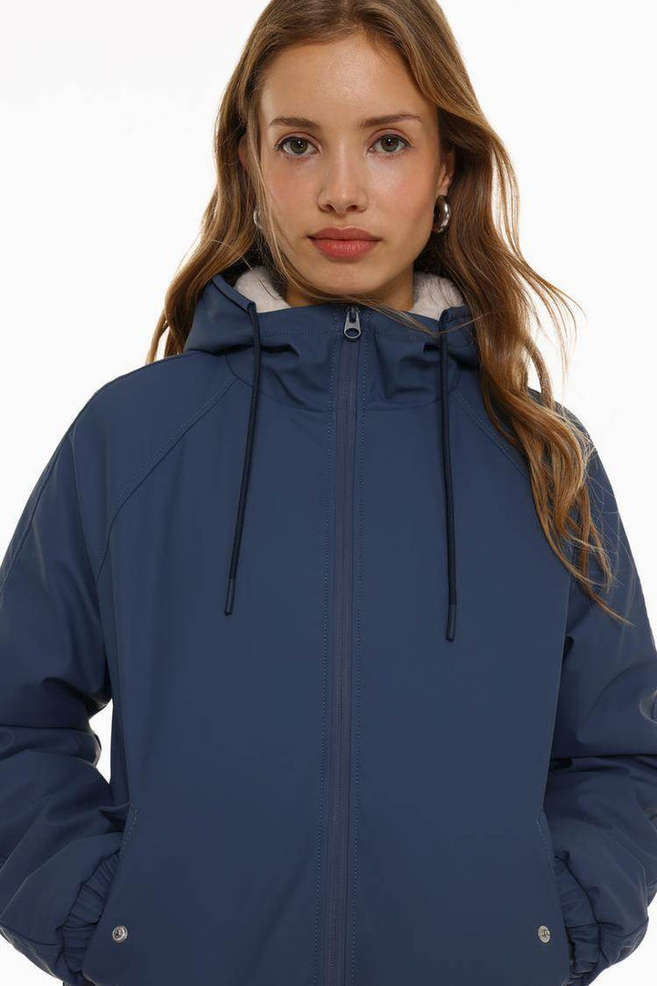 Close-up front view of dark blue rubberised parka

