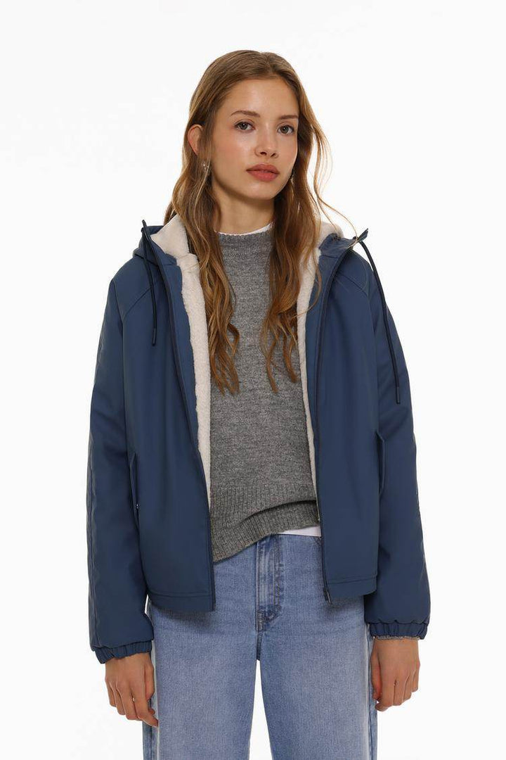 Model showcasing dark blue rubberised parka front

