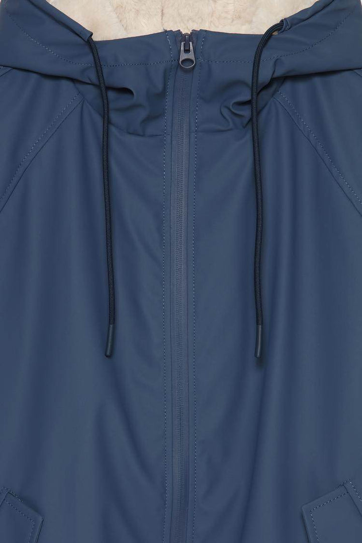 Close-up product image of dark blue rubberised parka

