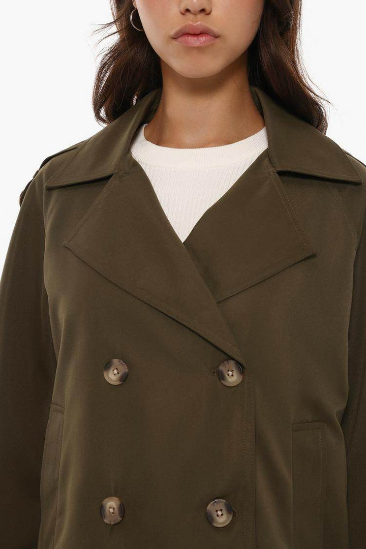 Close-up front view of dark green trench coat

