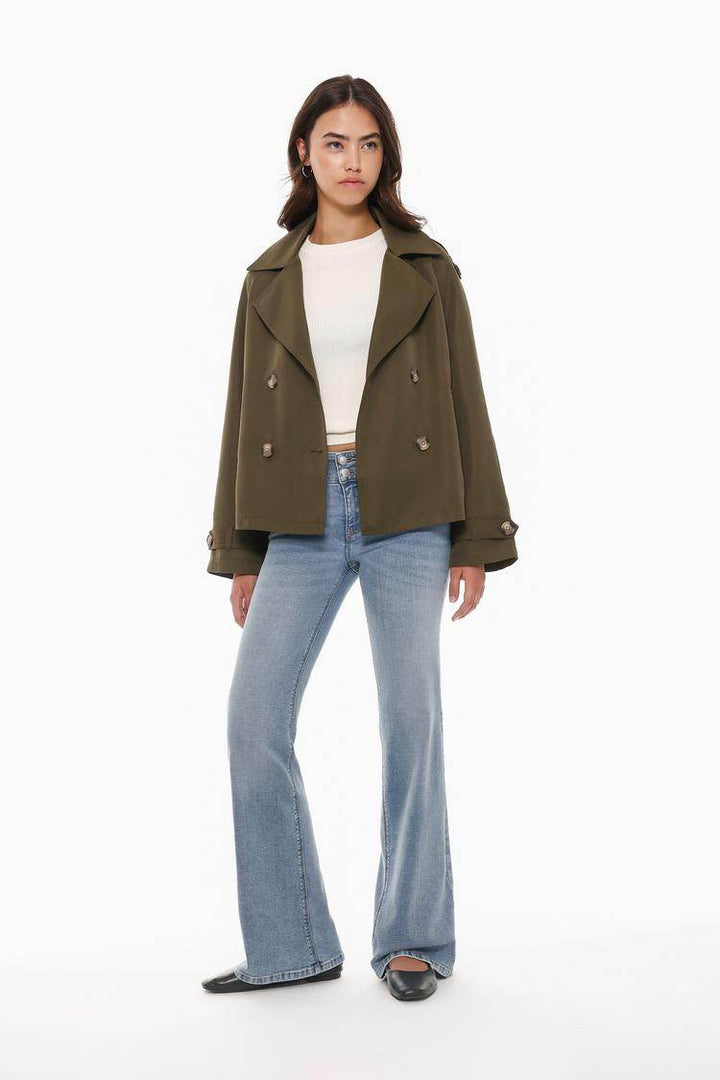 Full body front view of woman wearing dark green trench coat

