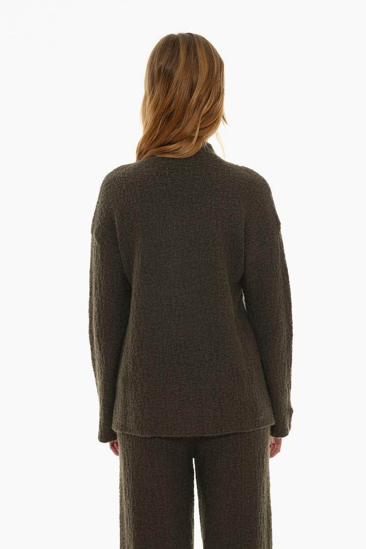 Back view of the women's dark green textured knit sweater

