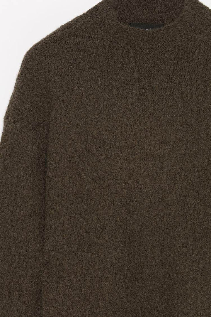 Close-up product image of dark green textured knit

