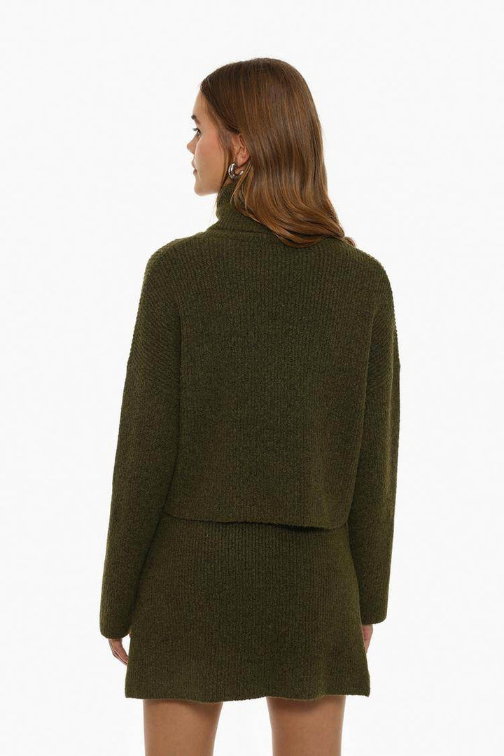 Back view of the women's dark green turtleneck sweater

