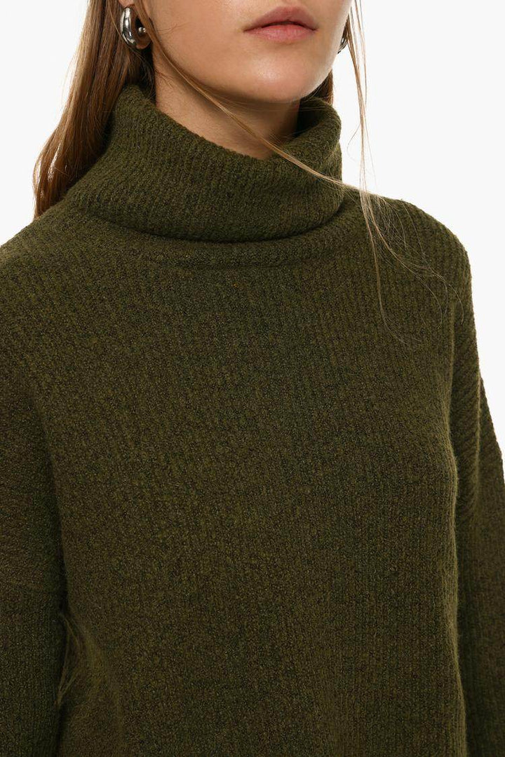 Close-up front view of dark green turtleneck sweater

