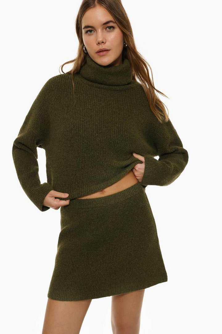 Front view of women's dark green turtleneck sweater

