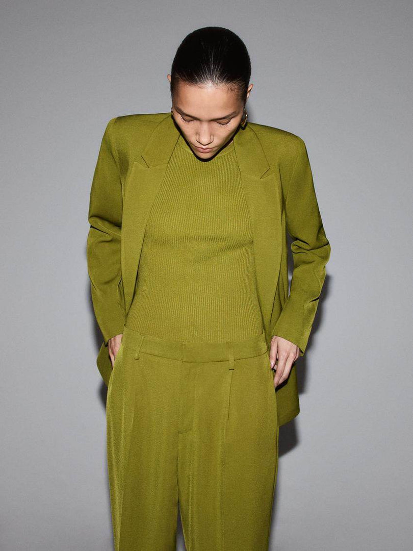 Front view of a stylish green blazer on a woman

