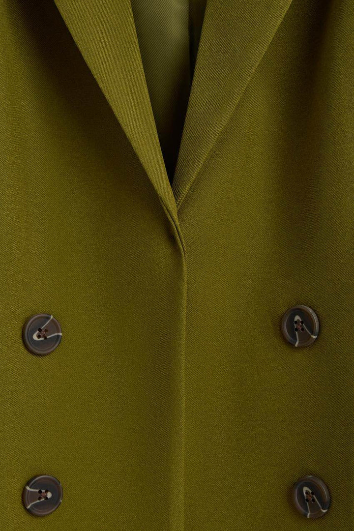 Close-up of the green blazer's fabric texture

