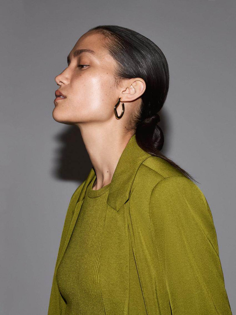 Zoomed in side view of the green blazer

