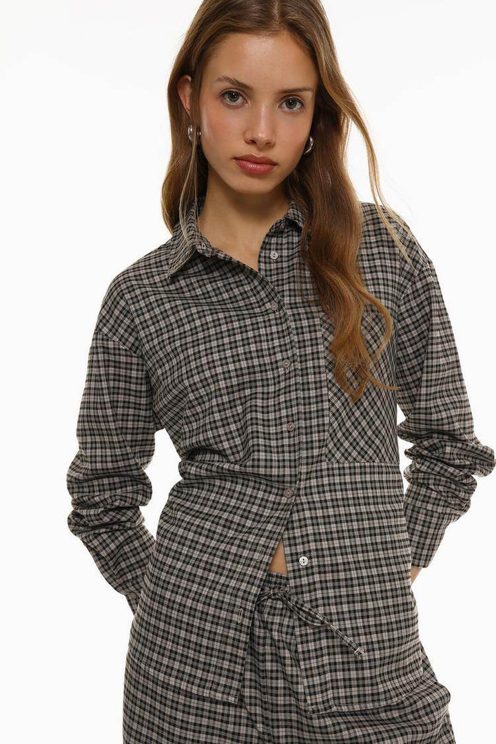 Model showcasing front of grey checked shirt

