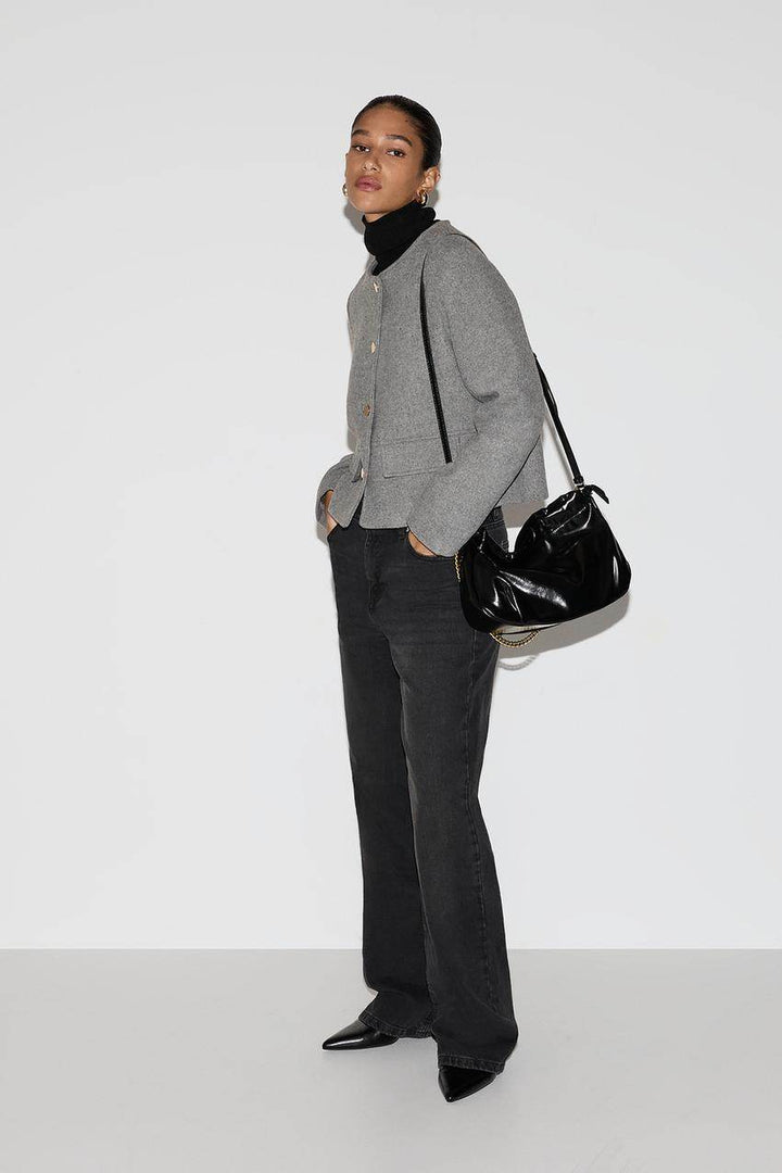 Side view of a grey women's cloth jacket
