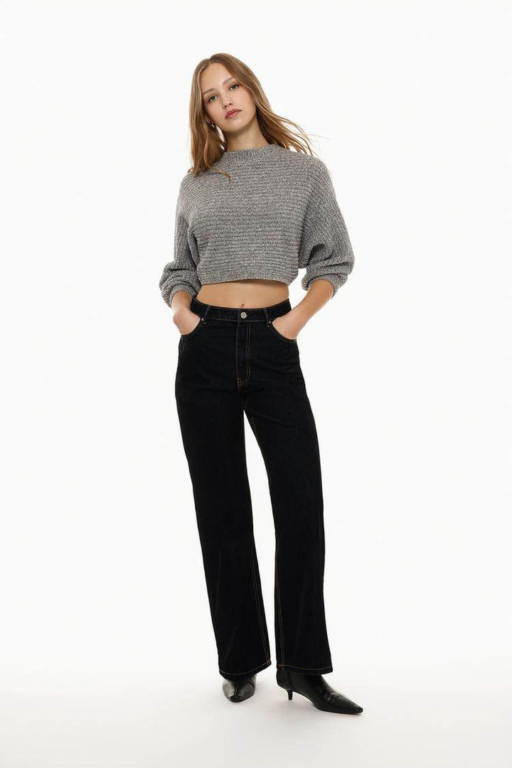 Full body front view of woman wearing grey cropped chenille sweater

